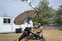 U.S. Air Force Senior Airman Michael Caravalho, 150th Electronic Warfare Squadron, space operator, makes adjustments to the satellite during Exercise Cobra Gold 2025 in Camp Suranaree, Thailand, Feb. 26, 2025.