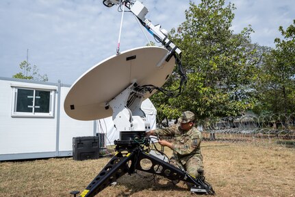 U.S. Air Force Senior Airman Michael Caravalho, 150th Electronic Warfare Squadron, space operator, makes adjustments to the satellite during Exercise Cobra Gold 2025 in Camp Suranaree, Thailand, Feb. 26, 2025.