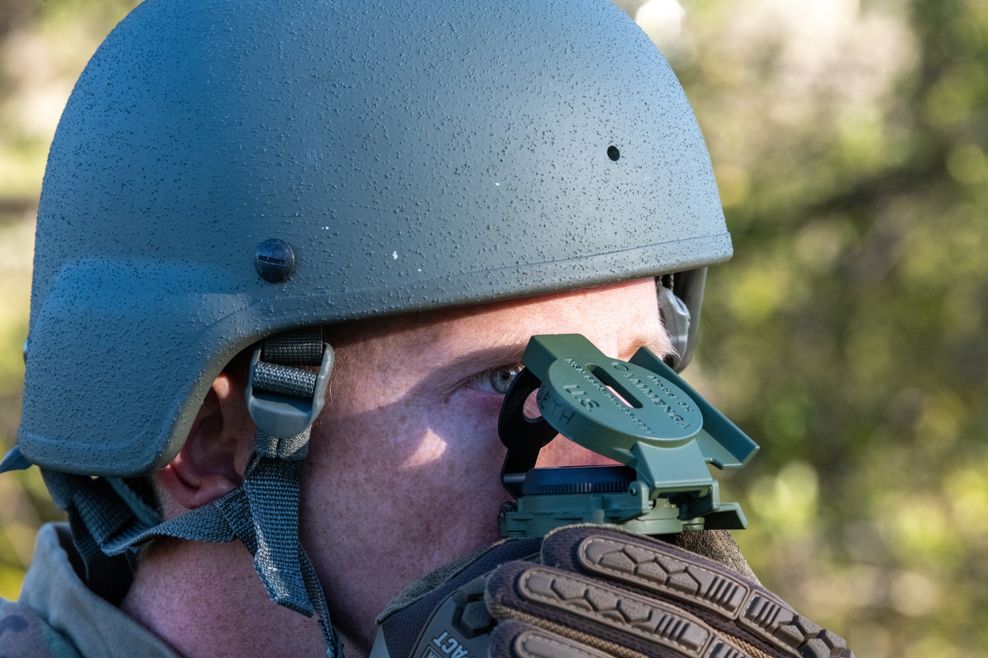 An Airman looks into a compass