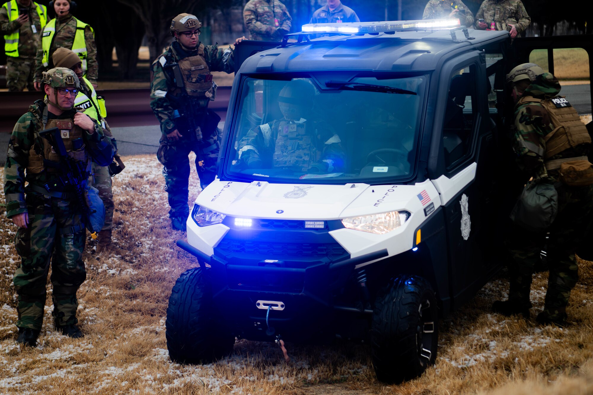 374th Security Forces Squadron Defenders secure a simulated active shooter suspect in a patrol vehicle.