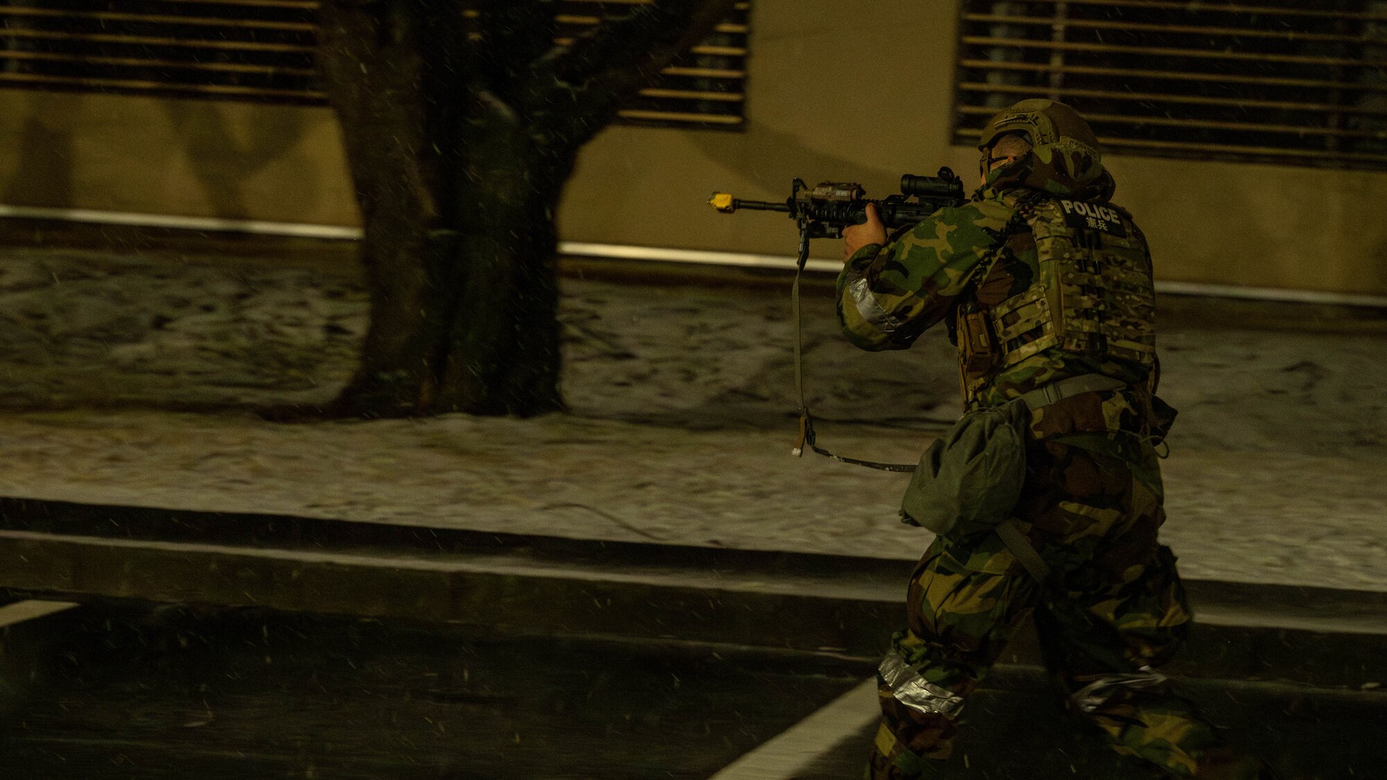 A member with a weapon clearing an area