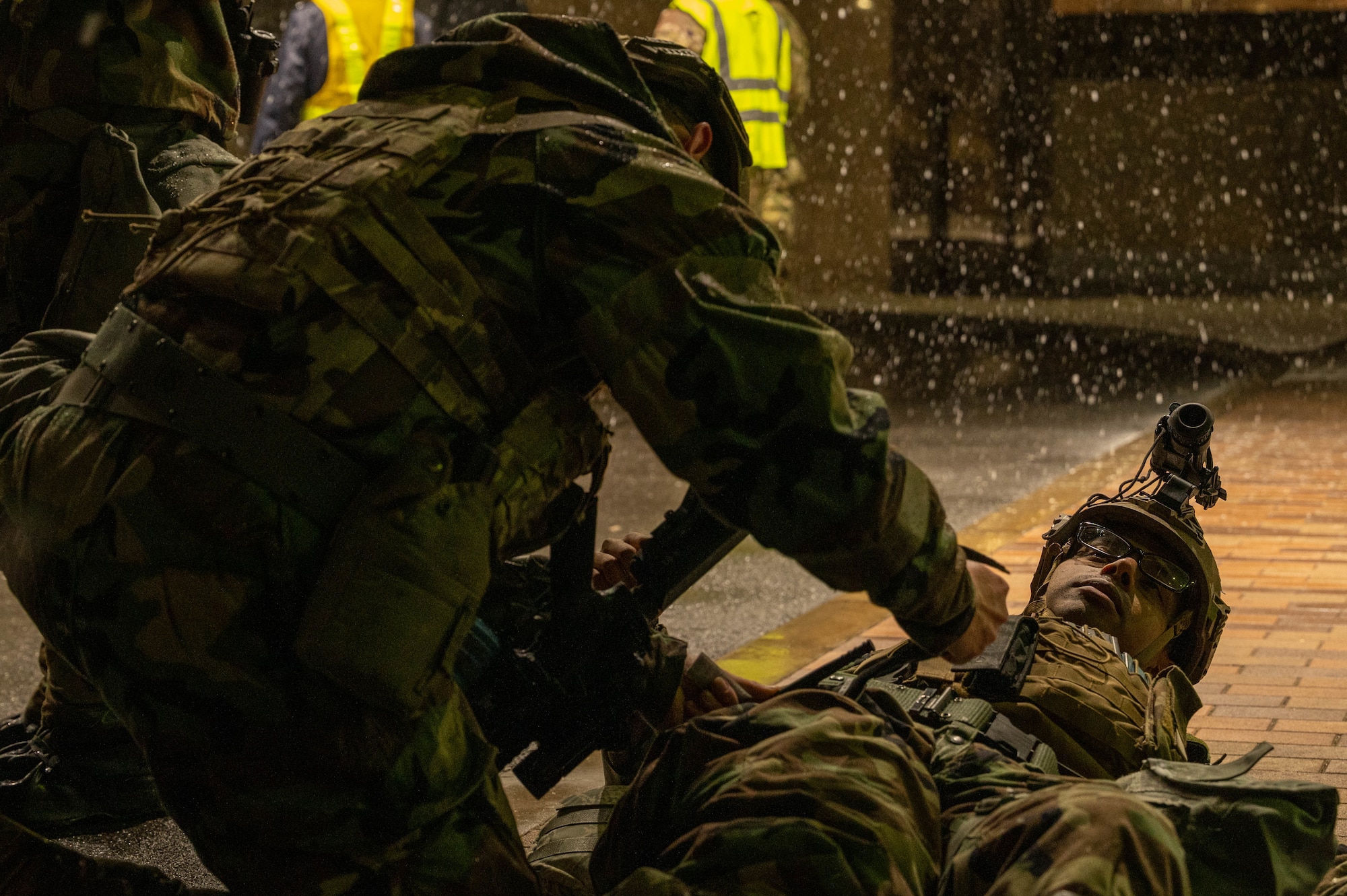 A member providing first aid on another individual.