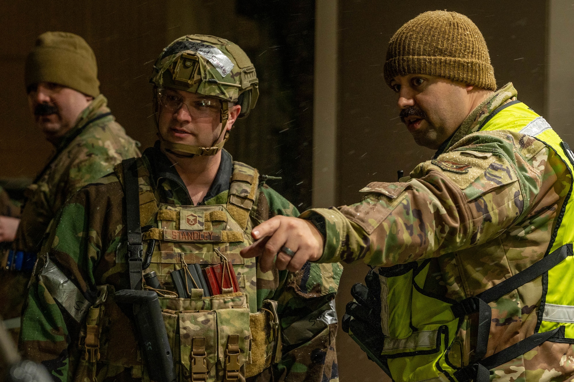 two military members pointing
