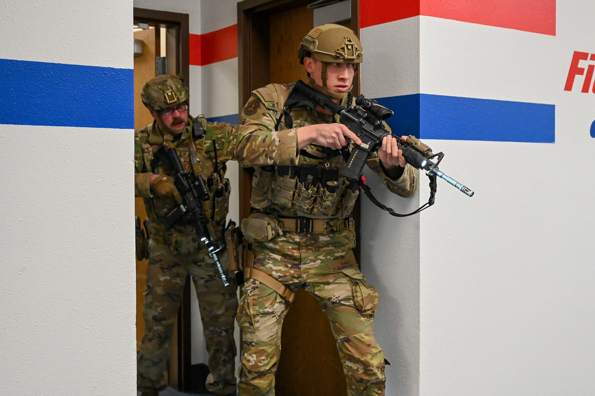 Uniformed personnel provide aid and security to simulated victims of a simulated active shooter.