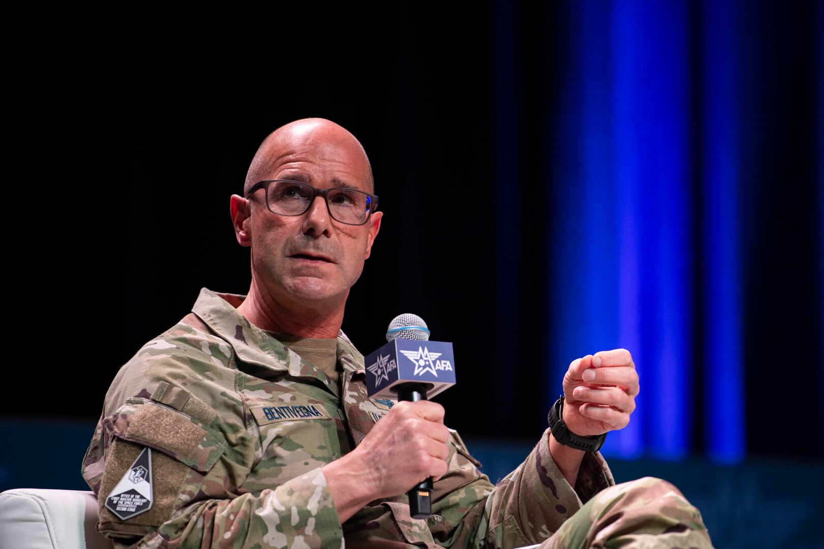 A military member speaks at a panel.