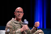 A military member speaks at a panel.