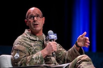 A military member speaks at a panel.