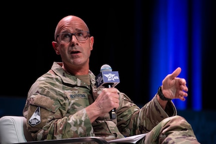 A military member speaks at a panel.