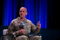 A military member speaks at a panel.
