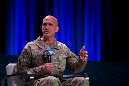 A military member speaks at a panel.