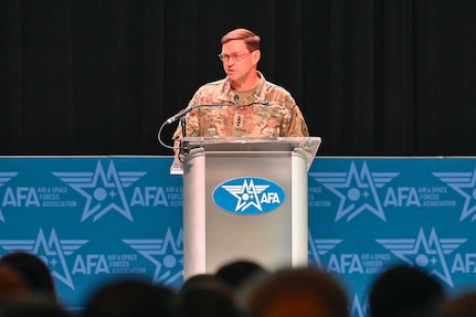 A Space Force general speaks at a lectern.