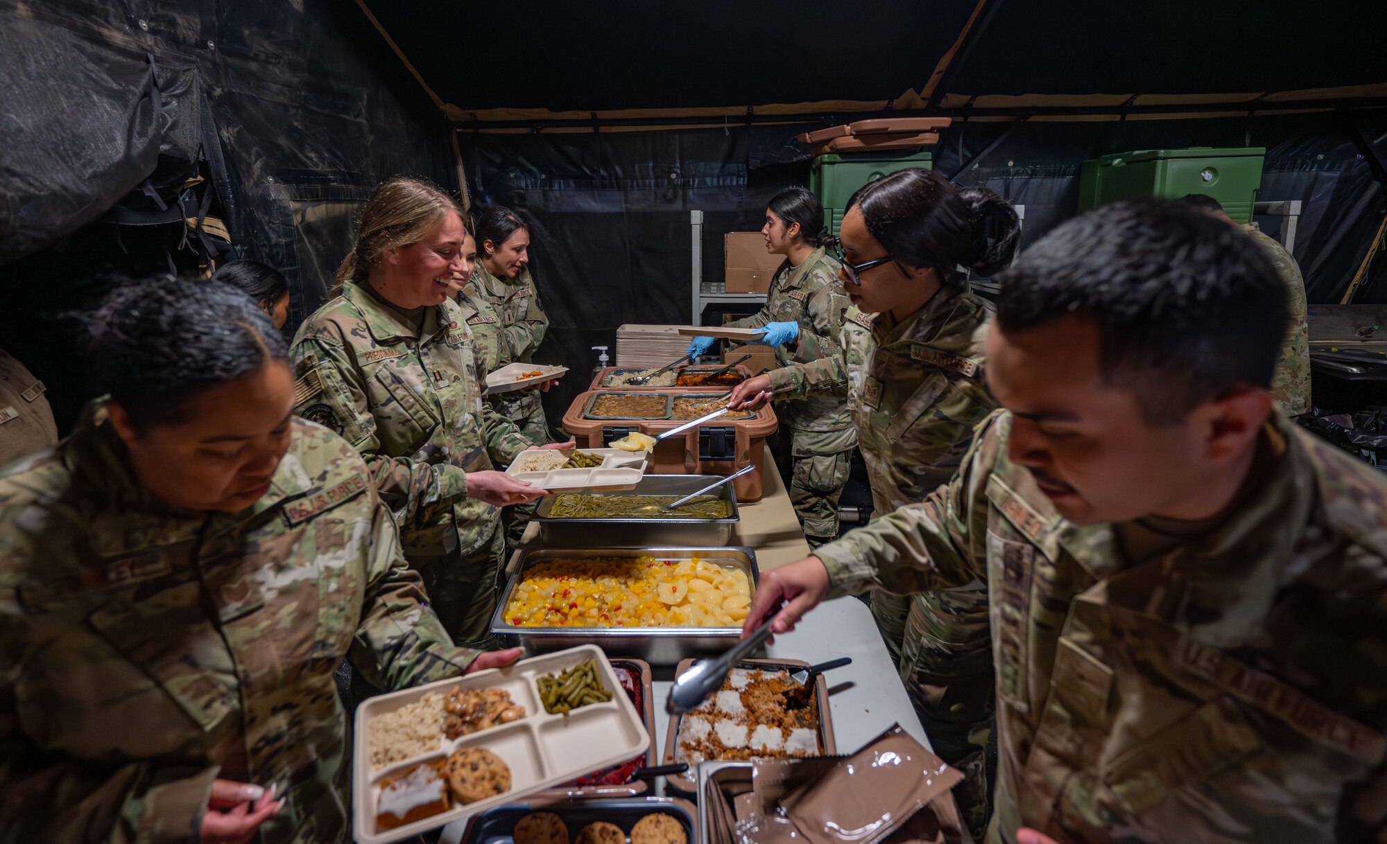 Airmen assigned to the 920th Force Support Squadron served a hot meal from inside the Single Pallet Expeditionary Kitchen during MEDBEACH 2025 at Avon Park Auxiliary Field, Florida, Feb. 25, 2025. Citizen Airmen from the 920th Aeromedical Staging Squadron, alongside joint partners, honed their medical and patient evacuation skills during hands-on training, reinforcing en route patient staging capabilities and wartime medical operations. (U.S. Air Force photo by Tech. Sgt. Darius Sostre-Miroir)