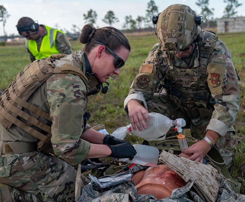 Maj. Danielle Humphrey, 920th Rescue Wing Tactical Medical Augmentation Team concept lead nurse, and Tech. Sgt. Kyle Wheeler, 920th Security Forces Squadron fire team leader, performed critical care on a patient during a simulated medical evacuation at Avon Park Auxiliary Airfield, Feb. 26, 2025. Citizen Airmen from the 920th ASTS, alongside joint and international partners, honed their medical and patient evacuation skills during MEDBEACH 2025, a hands-on training exercise reinforcing en route patient staging capabilities and wartime medical operations. (U.S. Air Force photo by Tech. Sgt. Darius Sostre-Miroir)