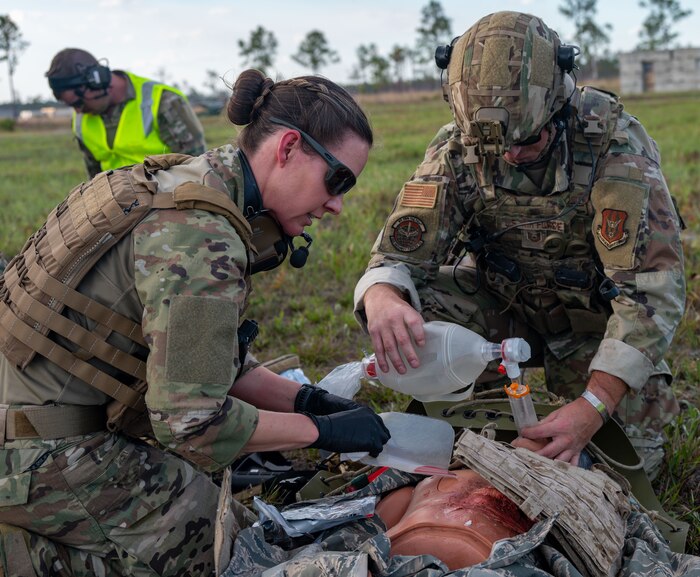 Maj. Danielle Humphrey, 920th Rescue Wing Tactical Medical Augmentation Team concept lead nurse, and Tech. Sgt. Kyle Wheeler, 920th Security Forces Squadron fire team leader, performed critical care on a patient during a simulated medical evacuation at Avon Park Auxiliary Airfield, Feb. 26, 2025. Citizen Airmen from the 920th ASTS, alongside joint and international partners, honed their medical and patient evacuation skills during MEDBEACH 2025, a hands-on training exercise reinforcing en route patient staging capabilities and wartime medical operations. (U.S. Air Force photo by Tech. Sgt. Darius Sostre-Miroir)
