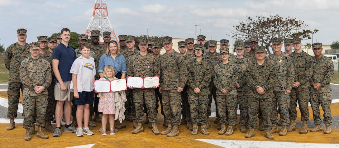 U.S. Marines across III Marine Expeditionary Force, pose for a group photo after a Purple Heart ceremony on Camp Kinser, Okinawa, Japan, Jan. 6, 2025. Chief Warrant Officer 2 William Faffler, a visual information officer with 3rd Marine Logistics Group, received two Purple Hearts, both for wounds sustained during combat operations in support of Operation Enduring Freedom in Helmand Province, Afghanistan, May and October of 2010. (U.S. Marine Corps photo by Lance Cpl. Weston Brown)