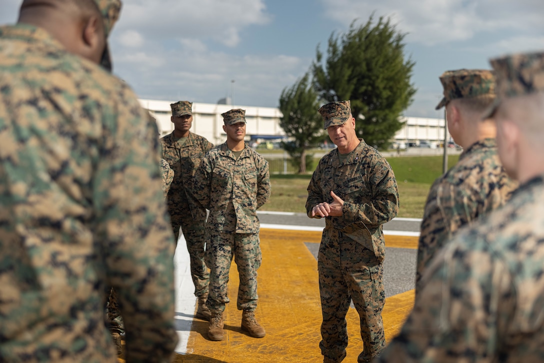U.S. Marine Corps Brig. Gen. Kevin G. Collins, middle, the commanding general of 3rd Marine Logistics Group (3rd MLG), speaks with Marines across III Marine Expeditionary Force before a Purple Heart ceremony for Chief Warrant Officer 2 William Faffler, a visual information officer with 3rd MLG, on Camp Kinser, Okinawa, Japan, Jan. 6, 2025. Faffler received two Purple Hearts, both for wounds sustained during combat operations in support of Operation Enduring Freedom in Helmand Province, Afghanistan, May and October of 2010. (U.S. Marine Corps photo by Lance Cpl. Weston Brown)