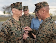 Okinawa, Japan — The wind was crisp as Marines stood in formation, with family and friends coming together in the winter morning. As the medal, the countenance of George Washington set in violet, was pinned over Faffler’s heart, his wife and children by his side, it was hard to not shed a tear as emotions were heightened during this special moment.