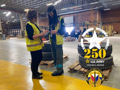 Cecilia Balleri, a supply technician and Italian host nation Army employee with the directorate of supply at Army Field Support Battalion-Africa (left), assists Giada Barontini with a supply request at Leghorn Army Depot’s shipping and receiving area in Livorno, Italy, March 5. Balleri said what the Army has done over the past 250 years is extremely important, including helping to liberate her country during World War II. (U.S. Army courtesy photo)