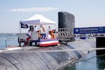 240809-N-SS900-1202 SAN DIEGO (Aug. 9, 2024) Capt. William Wiley speaks during a change of command ceremony for Commander Submarine Squadron (COMSUBRON) 11 held aboard Los Angeles-class fast-attack submarine USS Hampton (SSN 767) at Naval Base Point Loma, Aug. 9, 2024. During the ceremony, Wiley relieved Capt. Kenneth Douglas as commander of COMSUBRON 11. (U.S. Navy photo by Mass Communication Specialist 1st Class Aaron T. Smith)