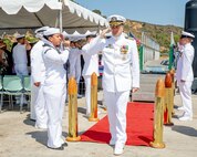240809-N-SS900-1226 SAN DIEGO (Aug. 9, 2024) Capt. William Wiley passes through sideboys during a change of command ceremony for Commander Submarine Squadron (COMSUBRON) 11 held aboard Los Angeles-class fast-attack submarine USS Hampton (SSN 767) at Naval Base Point Loma, Aug. 9, 2024. During the ceremony, Wiley relieved Capt. Kenneth Douglas as commander of COMSUBRON 11. (U.S. Navy photo by Mass Communication Specialist 1st Class Aaron T. Smith)