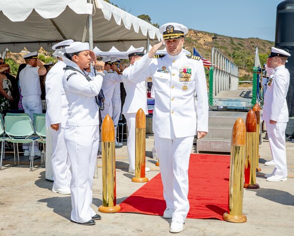 240809-N-SS900-1226 SAN DIEGO (Aug. 9, 2024) Capt. William Wiley passes through sideboys during a change of command ceremony for Commander Submarine Squadron (COMSUBRON) 11 held aboard Los Angeles-class fast-attack submarine USS Hampton (SSN 767) at Naval Base Point Loma, Aug. 9, 2024. During the ceremony, Wiley relieved Capt. Kenneth Douglas as commander of COMSUBRON 11. (U.S. Navy photo by Mass Communication Specialist 1st Class Aaron T. Smith)