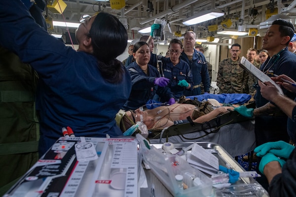 250205-N-QR506-1075 PHILIPPINE SEA (Feb. 5, 2025) Sailors assigned to the forward-deployed amphibious assault ship USS America (LHA 6), Fleet Surgical Team (FST) 7, and the 31st Marine Expeditionary Unit (MEU) assess a simulated casualty in the ship’s medical bay during a mass casualty drill in the Philippine Sea, Feb. 5. America, lead ship of the America Amphibious Ready Group, along with the 31st Marine Expeditionary Unit, are underway conducting routine operations in the U.S. 7th Fleet area of operations. U.S. 7th Fleet is the U.S. Navy’s largest forward-deployed numbered fleet, and routinely interacts and operates with allies and partners in preserving a free and open Indo-Pacific region (U.S. Navy photo by Mass Communication Specialist Seaman Jeadan Andre)