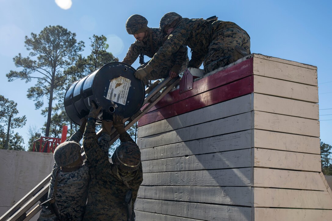 U.S. Marines with II Marine Expeditionary Force Support Battalion, II MEF Information Group, participate in a leadership reaction course during a battalion field exercise at Marine Corps Base Camp Lejeune, North Carolina, Jan. 8, 2025. The battalion FEX was designed to increase proficiency in individual and crew-served marksmanship, basic combat skills and improve chemical, biological, radiological, and nuclear readiness. (U.S. Marine Corps photo by Sgt. Jacquilyn Davis)