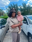 Female U.S. Army Soldier in uniform poses with young daughter