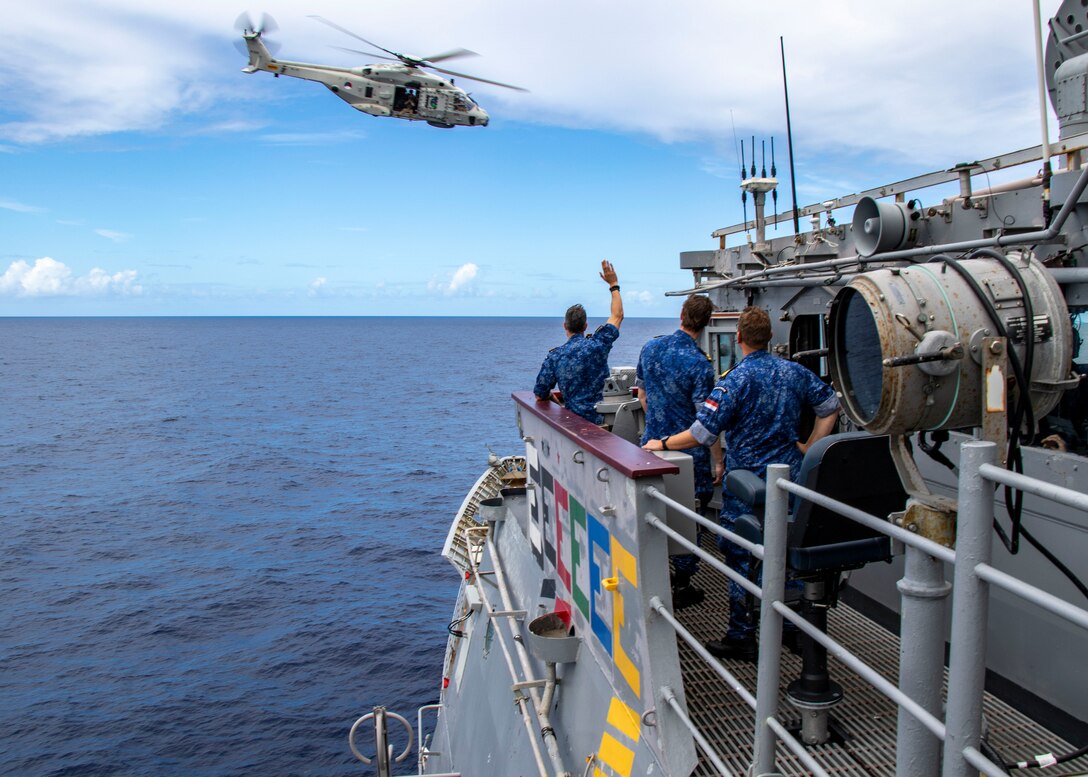 A NH-90 Neptune helicopter assigned to Royal Netherlands Navy Holland-class offshore patrol vessel HNLMS Groningen (P843) flies over Ticonderoga-class guided-missile cruiser USS Normandy (CG 60) while conducting trilateral operations including the U.S., United Kingdom Royal Navy, and Royal Netherlands Navy in the Caribbean Sea, March 3, 2025. USS Normandy is scheduled to protect U.S. interests in the region and strengthen maritime partnerships through trilateral and multinational maritime operations and Theater Security Cooperation (TSC) port visits. U.S. Naval Forces Southern Command/U.S. 4th Fleet is the maritime component of U.S. Southern Command and the trusted maritime partner for Caribbean, Central, and South American maritime forces leading to improved unity, security, and stability. (U.S. Navy photo by Mass Communication Specialist 1st Class Samantha Oblander/Released)