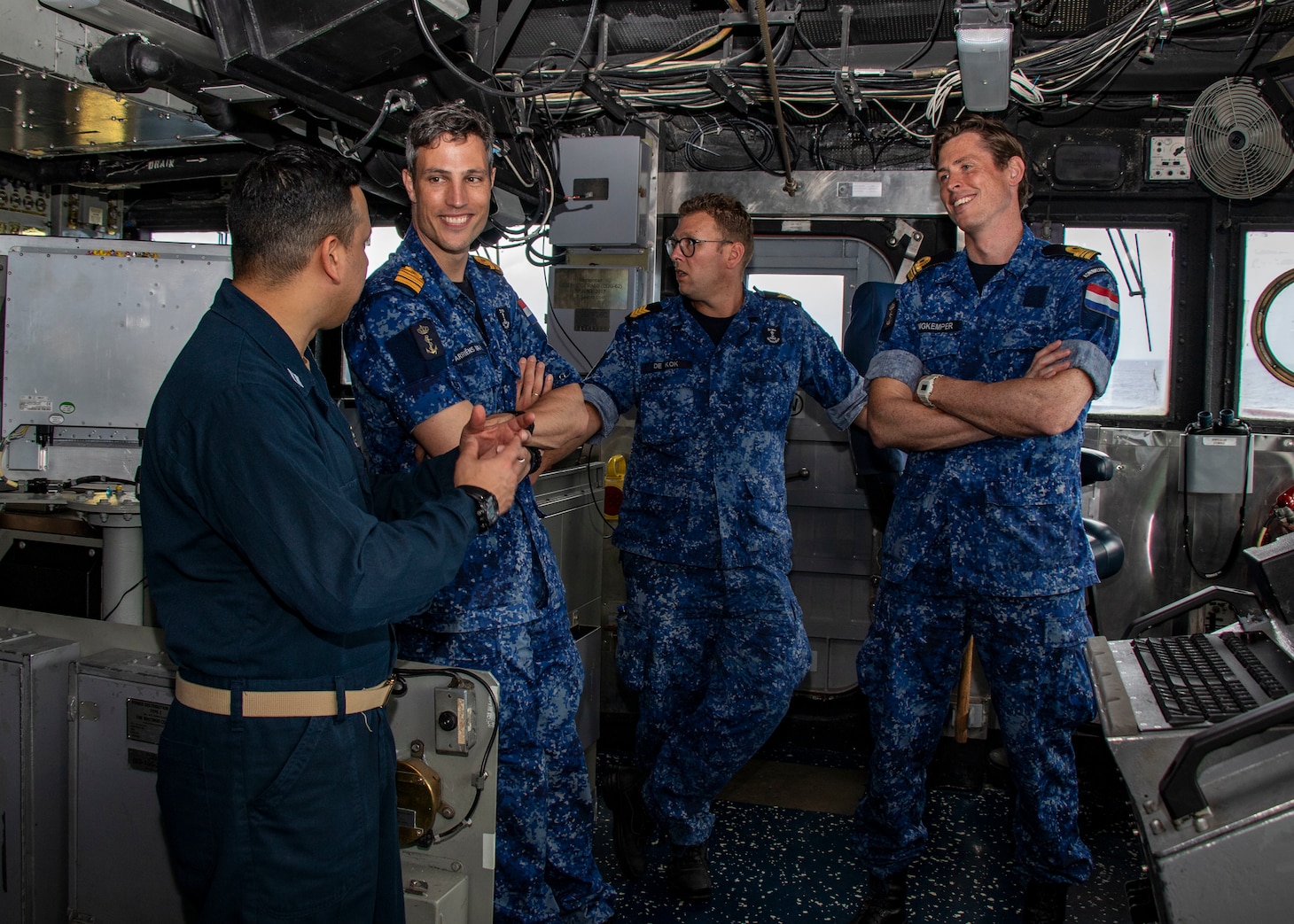 Lt. Anthony Rosario, from New York City, converses with Royal Netherlands Navy Holland-class offshore patrol vessel HNLMS Groningen (P843)’s captain, executive officer, and senior enlisted leader aboard Ticonderoga-class guided-missile cruiser USS Normandy (CG 60), while conducting trilateral operations including the U.S., United Kingdom Royal Navy, and Royal Netherlands Navy in the Caribbean Sea, March 3, 2025. USS Normandy is scheduled to protect U.S. interests in the region and strengthen maritime partnerships through trilateral and multinational maritime operations and Theater Security Cooperation (TSC) port visits. U.S. Naval Forces Southern Command/U.S. 4th Fleet is the maritime component of U.S. Southern Command and the trusted maritime partner for Caribbean, Central, and South American maritime forces leading to improved unity, security, and stability. (U.S. Navy photo by Mass Communication Specialist 1st Class Samantha Oblander/Released)