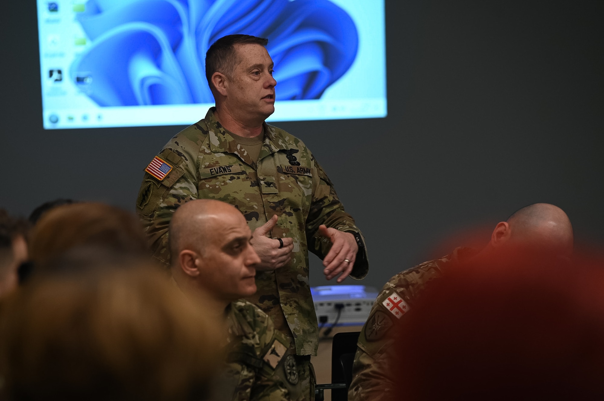 commander discusses with participants