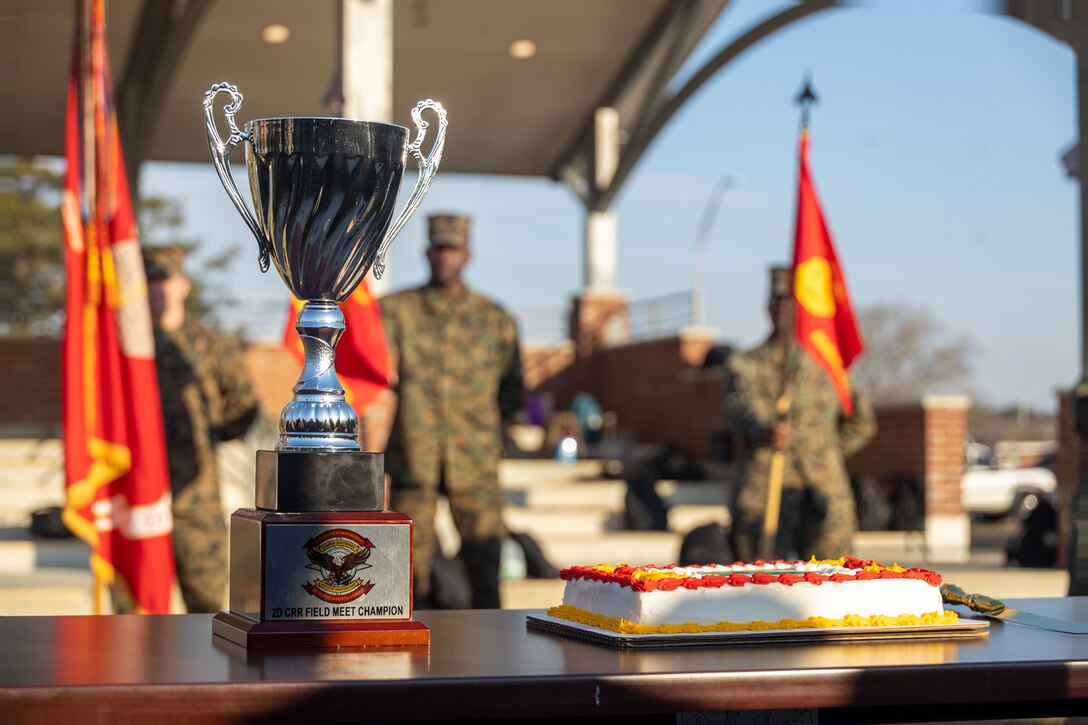 A trophy and a birthday cake sit on a table prior to the 2nd Combat Readiness Regiment, 2nd Marine Logistics Group, field meet, celebrating their first birthday as a regiment on Camp Lejeune, North Carolina, Feb. 27, 2025. 2nd CRR conducted the field meet, which consisted of various athletic events to promote physical fitness, cohesion and camaraderie, in order to celebrate the regiment’s first birthday. (U.S. Marine Corps photo by Cpl. Jessica J. Mazzamuto)