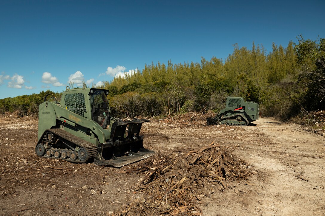 U.S. Marines with Marine Wing Support Squadron (MWSS) 272 clear a landing zone site near the U.S. Navy's Atlantic Undersea Test and Evaluation Center on Andros Island, Bahamas, Feb. 26, 2025. MWSS-272 deployed to the Bahamas to conduct aviation ground support rehearsals and refine distributed aviation operations for 2nd Marine Aircraft Wing. (U.S. Marine Corps photo by Lance Cpl. Mya Seymour)