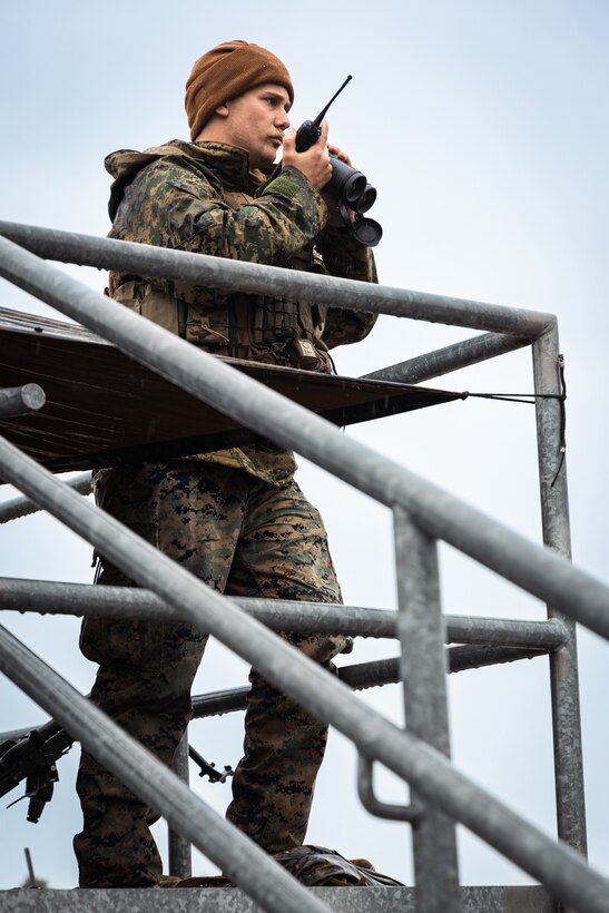 U.S. Marine Corps Sgt. Vaughan Lanier, a North Carolina native and a chief scout with Fox Company, 2nd Battalion, 2nd Marine Regiment, uses his radio to communicate with other Marines during an embassy reinforcement mission as part of a training exercise for the 26th Marine Expeditionary Unit at Camp Lejeune, North Carolina, Jan. 18, 2025. The 26th Marine Expeditionary Unit conducted a Marine Air-Ground Task Force interoperability exercise to rehearse and refine tactics, techniques, and procedures as the command element of a MAGTF in preparation for a wide array of potential future missions, to include personnel recovery, embassy reinforcement, foreign humanitarian assistance, and non-combatant evacuation operations. (U.S. Marine Corps photo by Lance Cpl. Osmar VasquezHernandez)