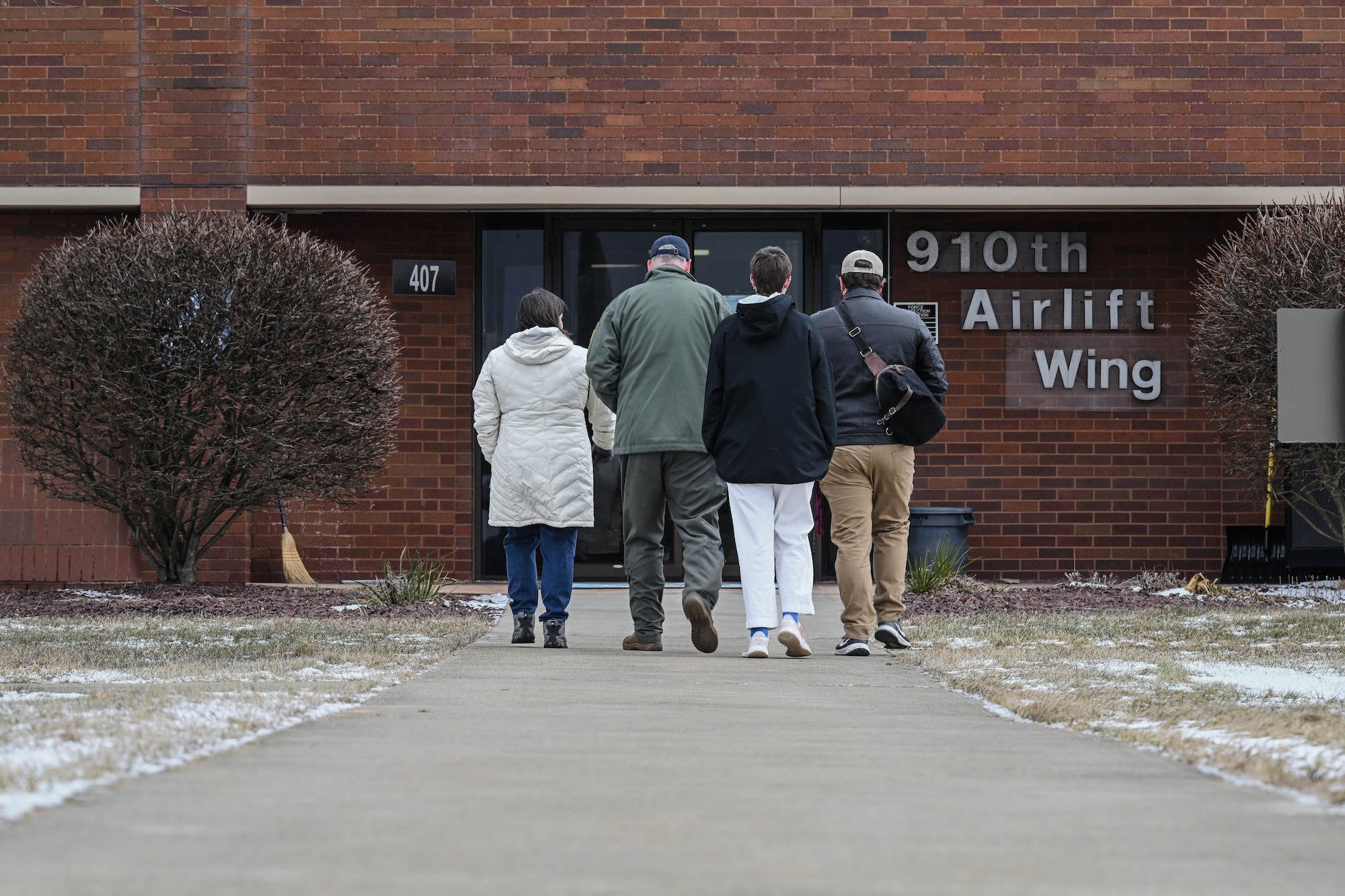 Col. Michael Maloney, 910th Airlift Wing commander, walks with his family after landing from his “fini-flight” at Youngstown Air Reserve Station, Ohio, March 2, 2025.