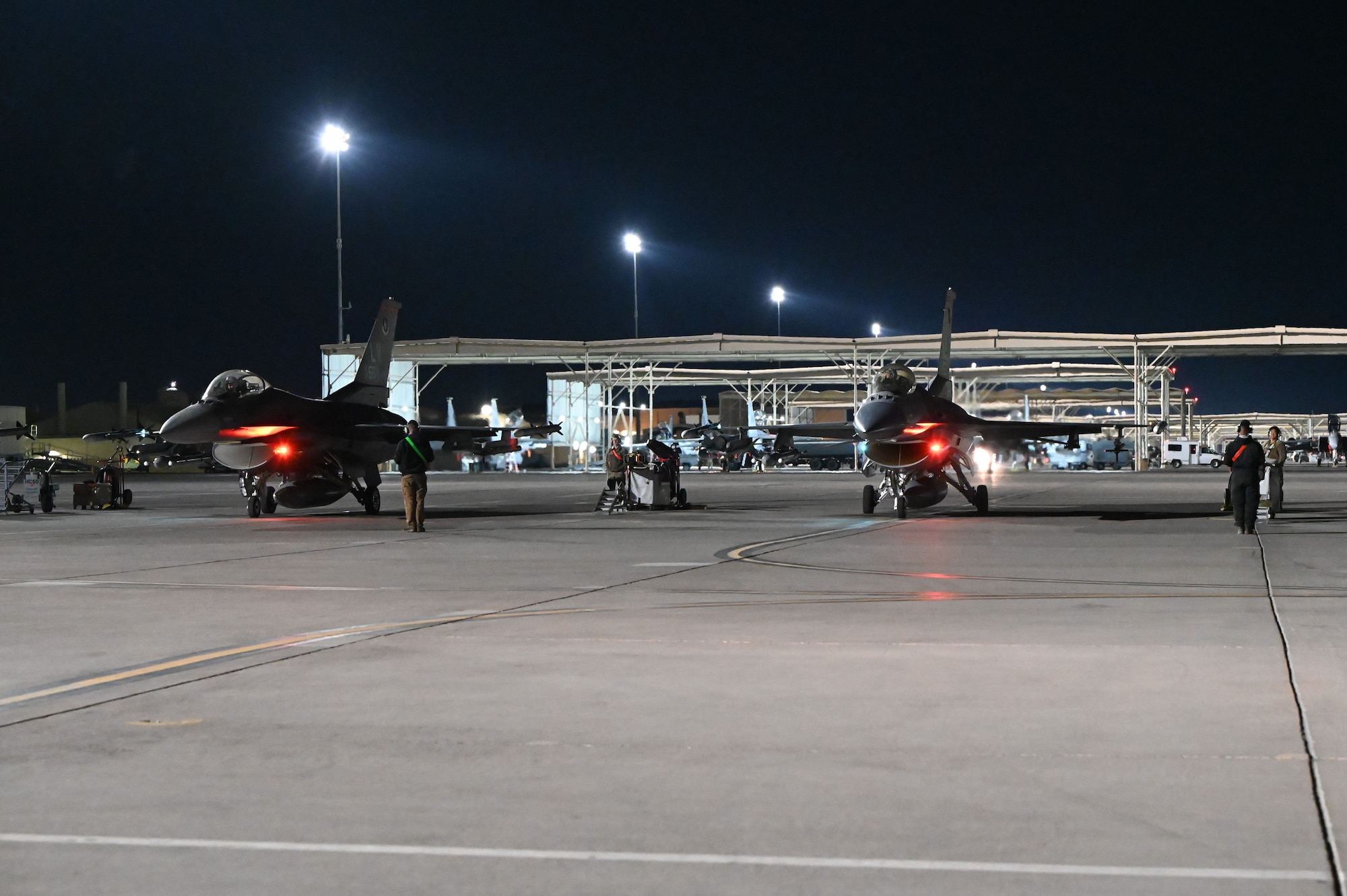 Two U.S. Air Force F-16 Fighting Falcons assigned to the 706th Aggressor Squadron, Nellis Air Force Base (AFB), Nevada, prepare for a night mission during Red Flag-Nellis 25-1, Jan. 29, 2025, at Nellis AFB, Nevada.