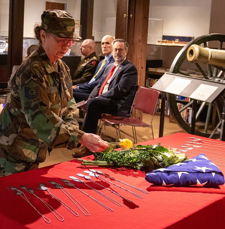 Rose Connelly, a volunteer with the Illinois State Military Museum, places a yellow rose in remembrance of a service member from Illinois who died during Operation Desert Storm at the Illinois Department of Veterans Affairs’ annual Operation Desert Storm Remembrance Ceremony Feb. 28 at the museum.