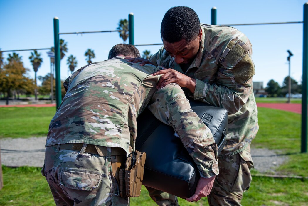 Airmen performing knee strikes.