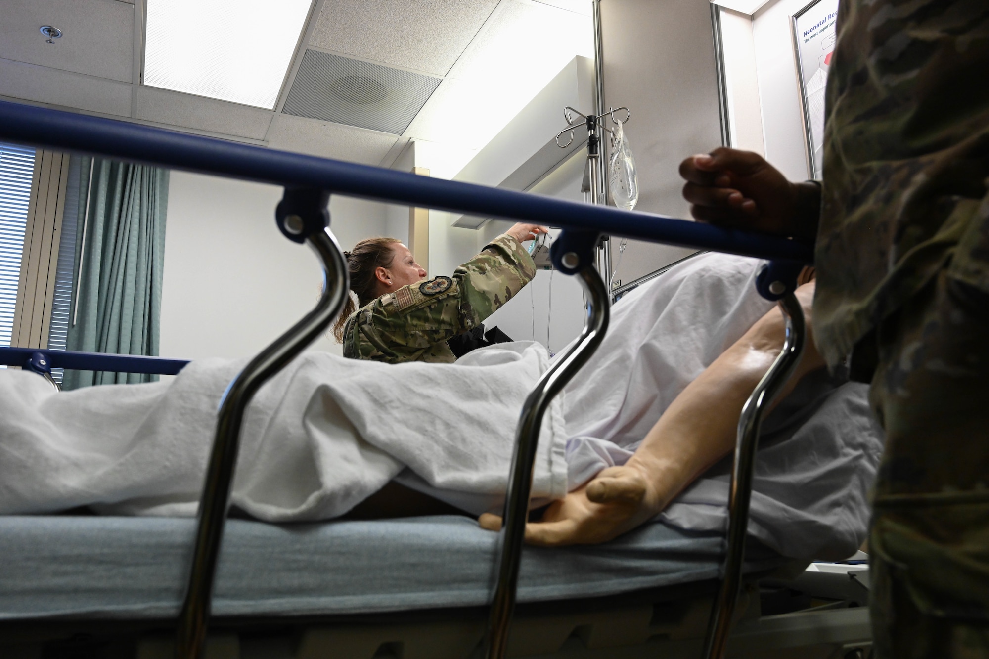 An Airman demonstrates functions of an intravenous (IV) insertion 