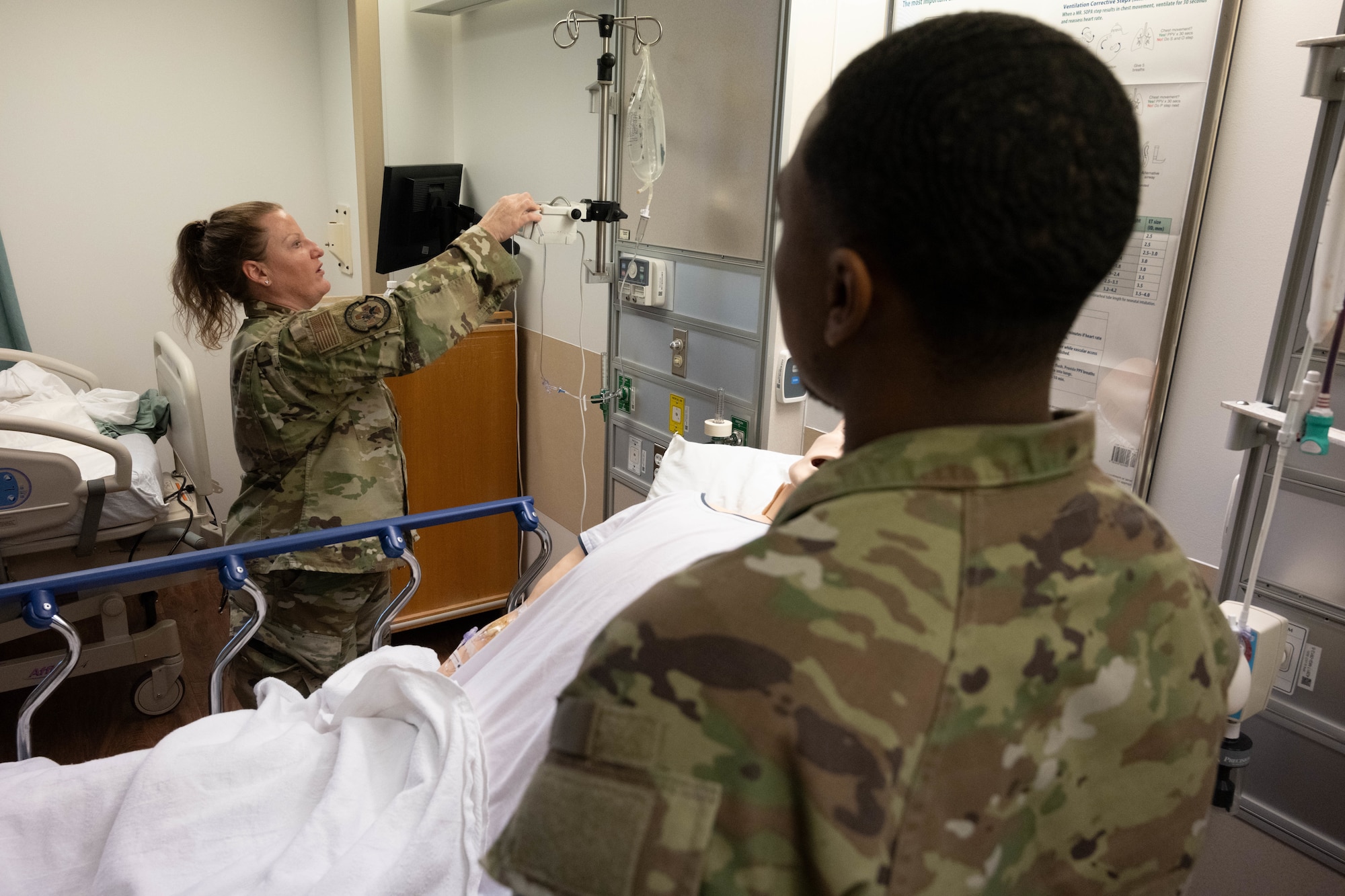 An Airman demonstrates different intravenous (IV) insertion functions.