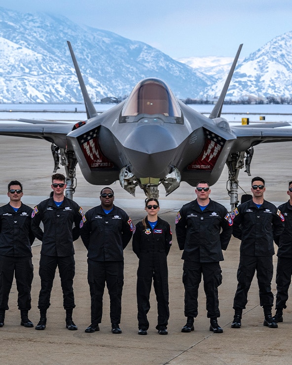 A photo of an F-35 crew chief standing in front of a jet