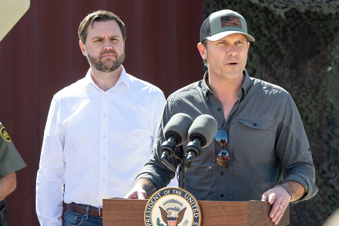 Two men stand near a lectern.