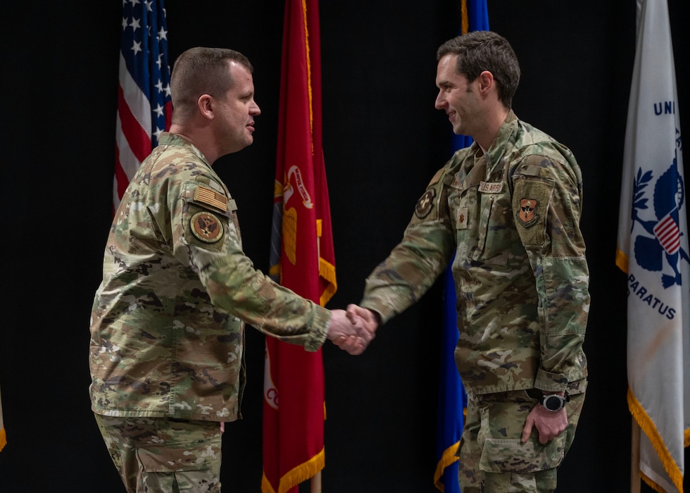 U.S. Air Force Col. John Davis, Air Education and Training Command command surgeon, coins a member of the 17th Medical Group at Goodfellow Air Force Base, Texas, Feb. 20, 2025. Davis recognized 17th MDG members who contributed to the ongoing efforts to enhance healthcare delivery and support Goodfellow’s readiness mission. (U.S. Air Force photo by Senior Airman Sarah Williams)