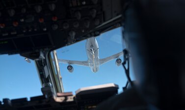 Airman look at another aircraft before refueling
