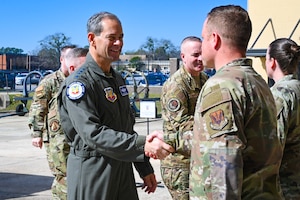 Air Force General shakes hand with an Airman