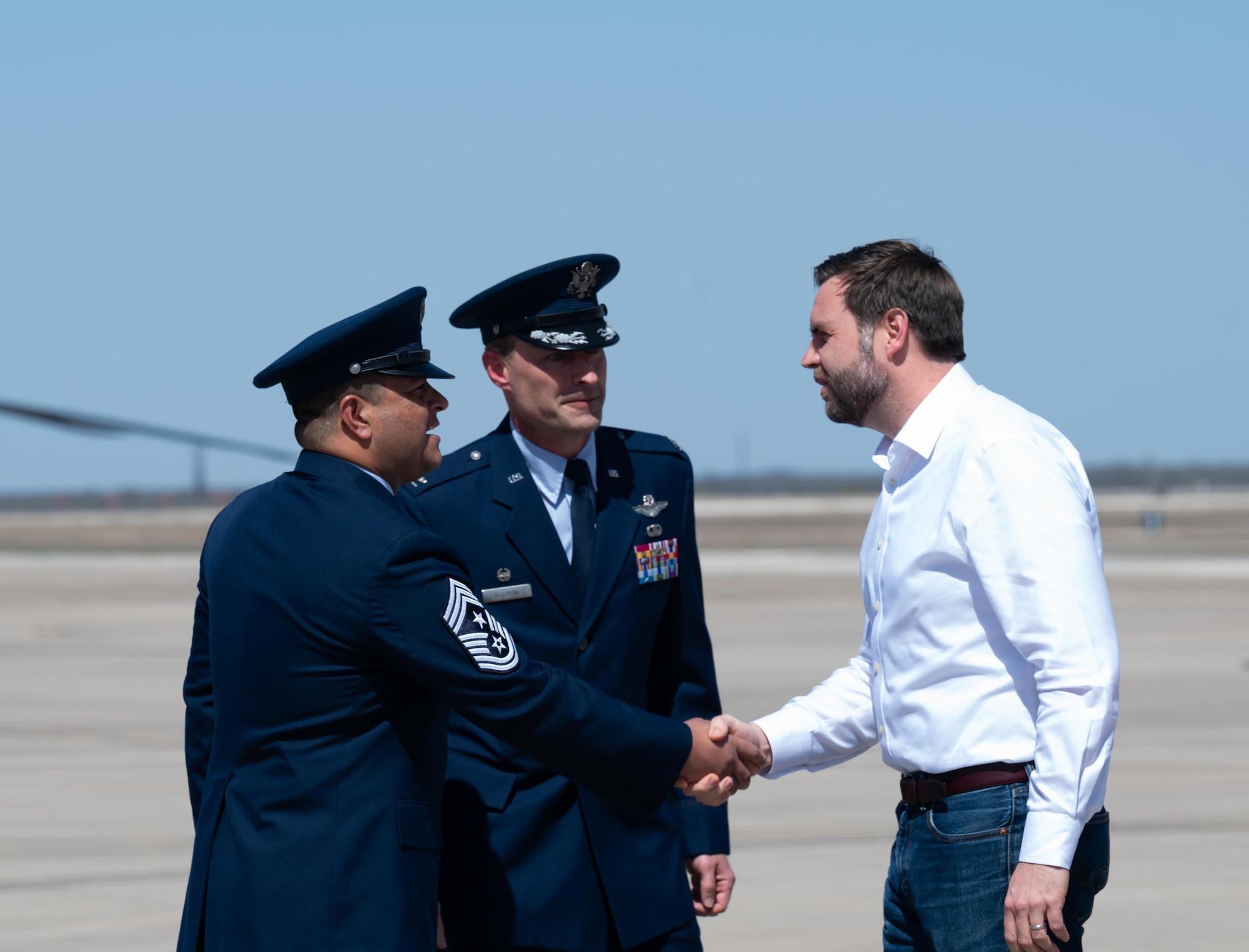 Vice President JD Vance is welcomed to Laughlin Air Force Base by Command Chief Master Sergeant Lester Largaespada, 47th Flying Training Wing command chief (left) and Col. Tyler Ellison, 47th FTW commander (middle). Vance, along with Defense Secretary Pete Hegseth and Director of National Intelligence Tulsi Gabbard arrived at Laughlin before beginning their visit to the southern border at Eagle Pass, Texas.  (U.S. Air Force photo by Airman 1st Class Harrison Sullivan)