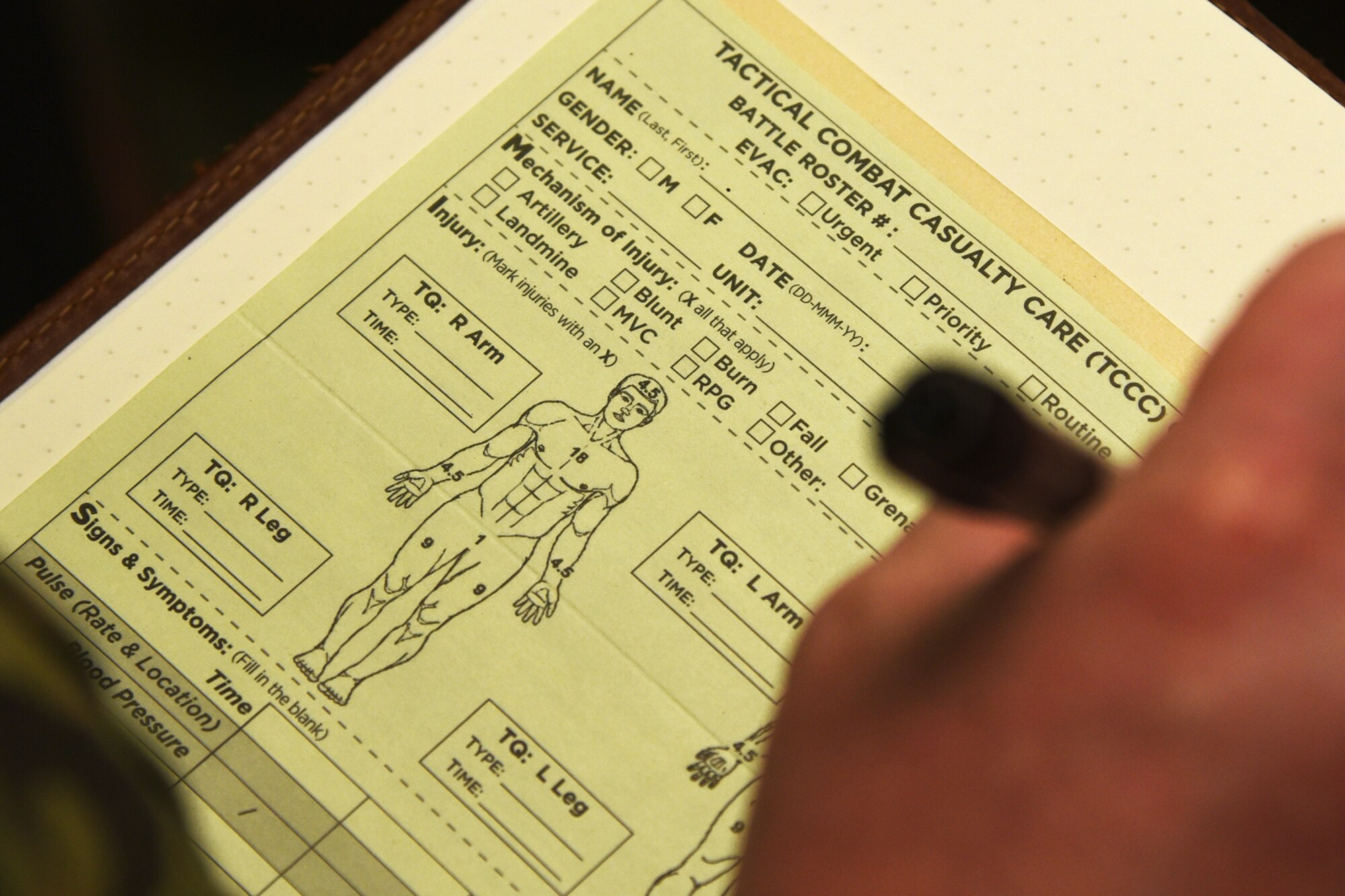 A close up of the TCCC patient assessment form.