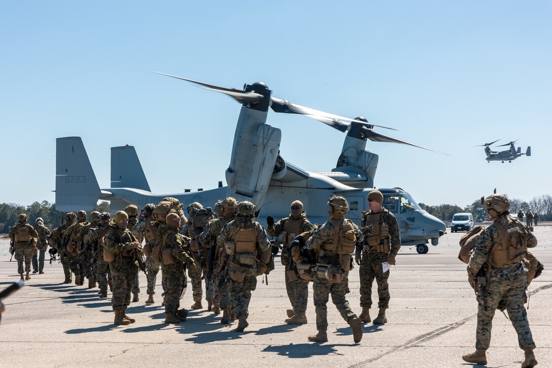 U.S. Marines with Golf Company, 2nd Battalion, 2nd Marine Regiment board an MV-22 osprey aircraft with Marine Medium Tiltrotor Squadron 162 (VMM-162) at Auxiliary Landing Field Bogue, North Carolina, Feb. 21, 2024. As the command element of a Marine Air-Ground Task Force, the 26th Marine Expeditionary Unit completed a certification exercise, conducted by Expeditionary Operations Training Group, to prepare for a diverse range of potential future missions, including personnel recovery, embassy reinforcement, foreign humanitarian assistance, and non-combatant evacuation operations. (U.S. Marine Corps photo by Lance Cpl. Jack Labrador)