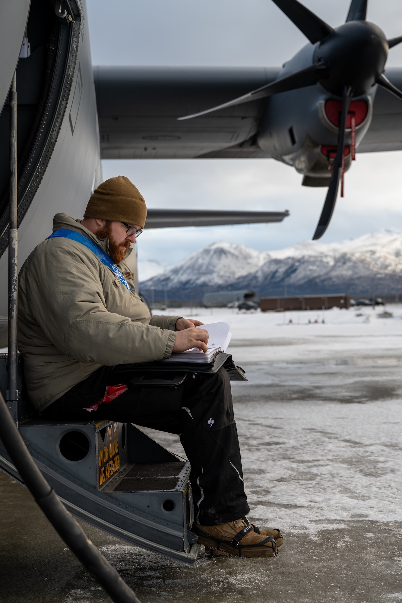 U.S. Air Force Tech. Sgt. Tyler Nelson, 317th Aircraft Maintenance Squadron flying crew chief and Lethal Expeditionary Airman Development course graduate, checks maintenance accuracy during Joint Pacific Multinational Readiness Center exercise 25-02 at Joint Base Elmendorf- Richardson, Alaska, Jan. 22, 2025. Nelson’s team maintained two C-130J Super Hercules in extreme cold weather conditions, enabling the 40th Airlift Squadron to deliver fully mission- capable aircraft and support nearly 10,000 Department of Defense service members during JPMRC 25-02. (U.S. Air Force photo by Airman 1st Class Jade M. Caldwell)