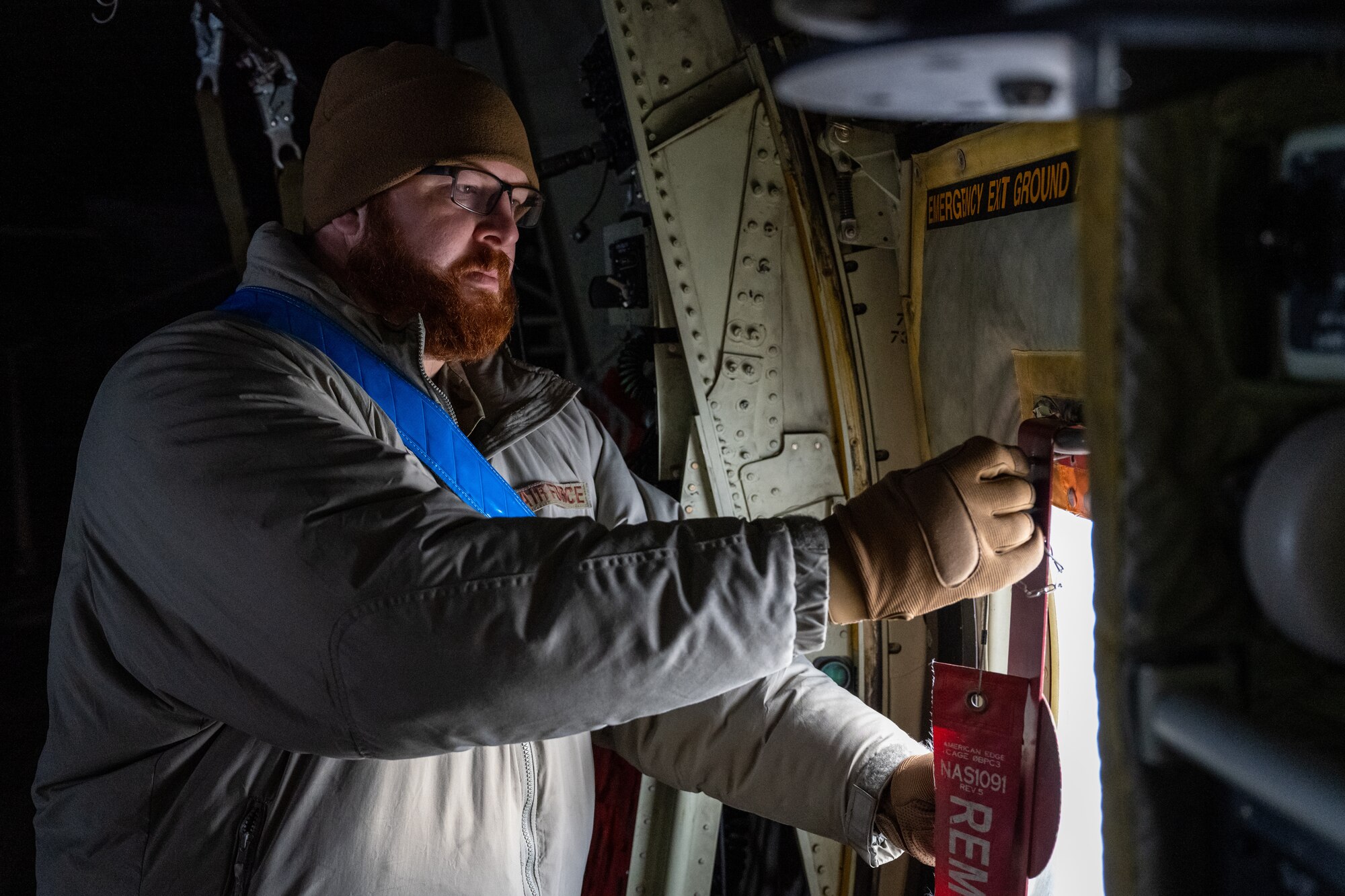 U.S. Air Force Tech. Sgt. Tyler Nelson, 317th Aircraft Maintenance Squadron flying crew chief and Lethal Expeditionary Airman Development course graduate, checks door locks during Joint Pacific Multinational Readiness Center exercise 25-02 at Joint Base Elmendorf-Richardson, Alaska, Jan. 22, 2025. JPMRC 25-02 required leaders that prioritize safety during extreme cold weather conditions to ensure the smooth coordination of the joint, multi-functional exercise. (U.S. Air Force photo by Airman 1st Class Jade M. Caldwell)